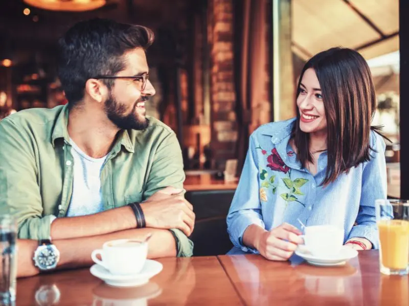 Woman and man taking over coffee. 